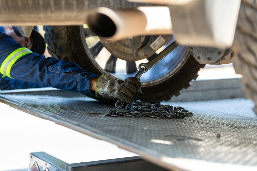 Arm of a Mechanic Repairing a Car